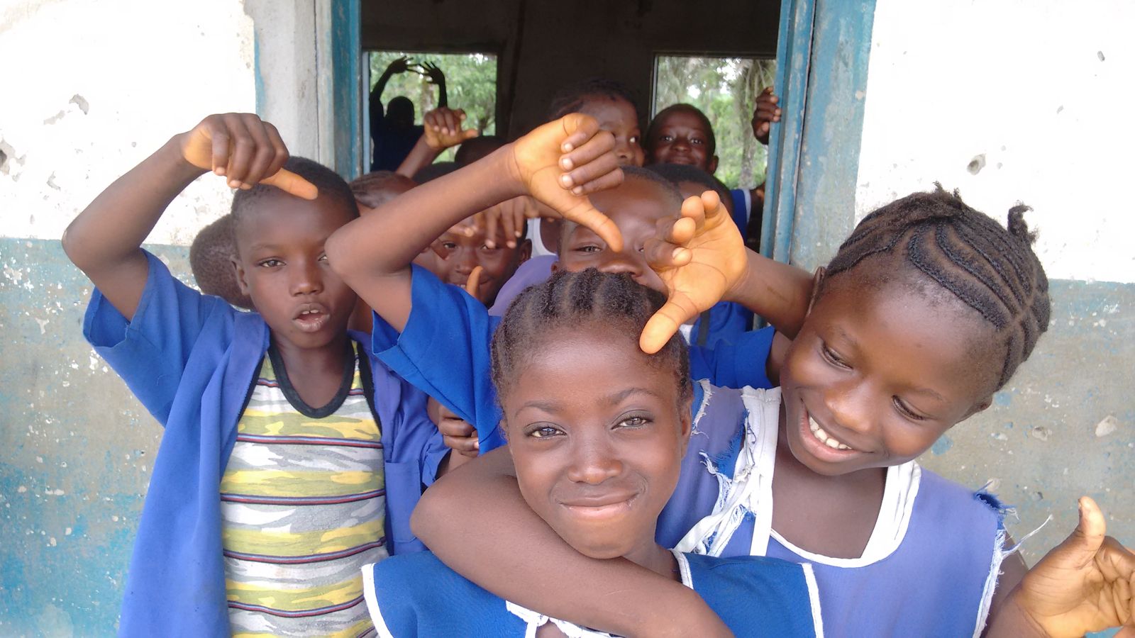 Smiling pupils in blue uniforms